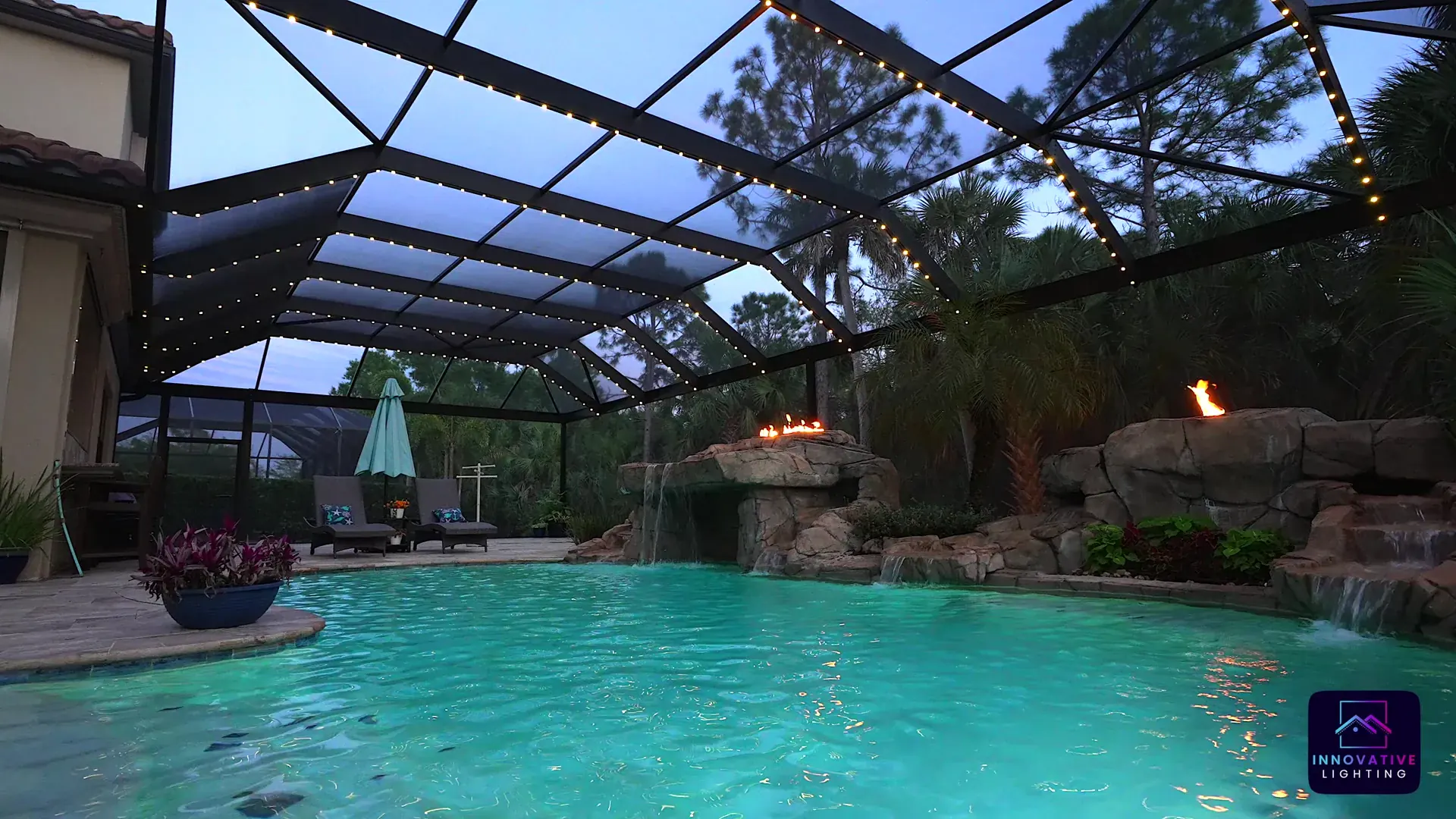 Pool cage and lanai lit in warm white at night