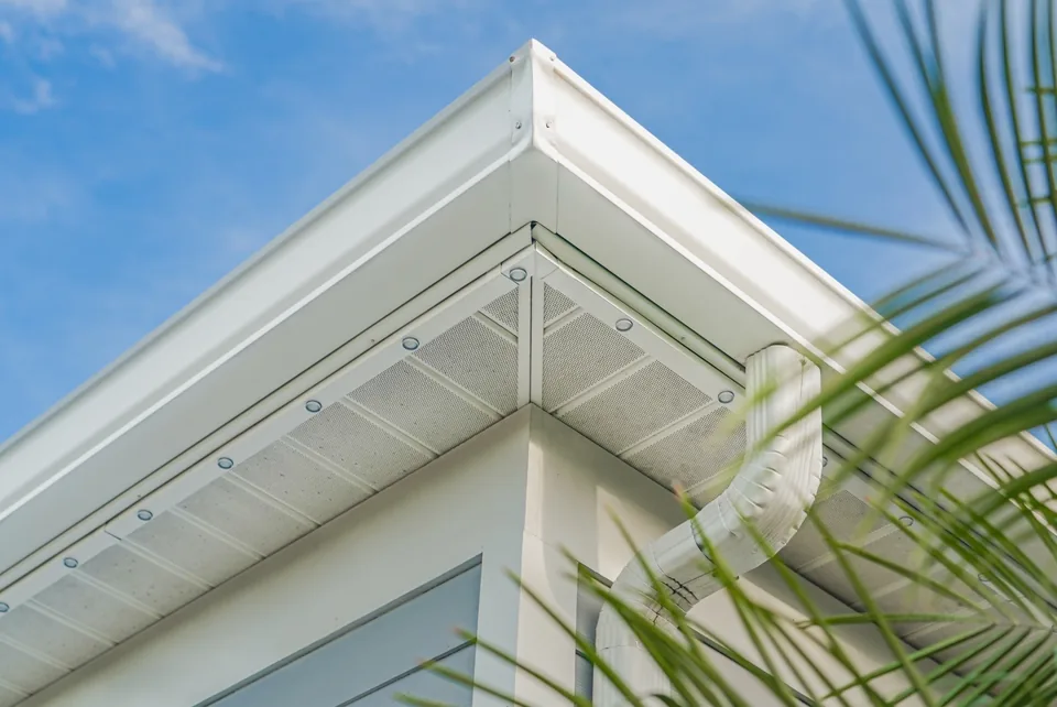 Close-up of color-matched channel at a soffit corner by day